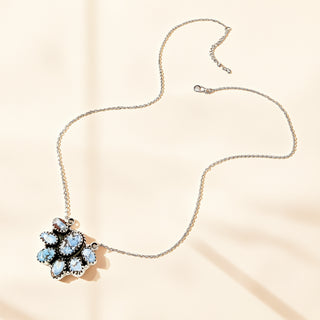 Silver necklace with turquoise pendant on a beige background
