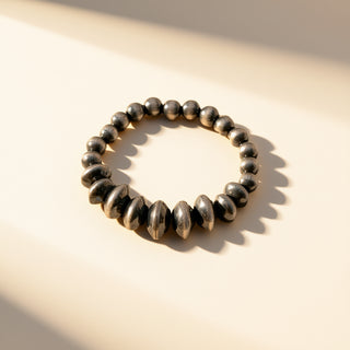 Black pearl ring on a beige background