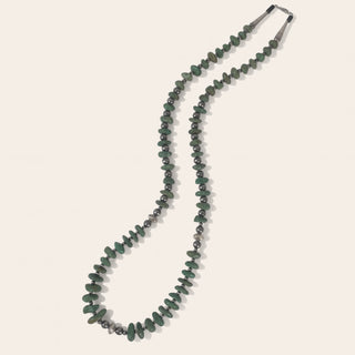 Necklace with green beads on a white background