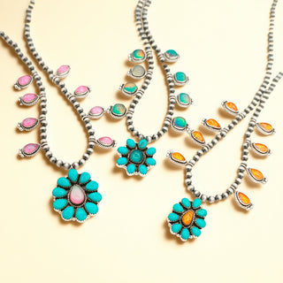 Necklaces with heart shaped pendants and turquoise stones on a beige background