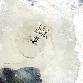 Close-up of a textured stamp with 'JCV' and 'Hespera' branding.