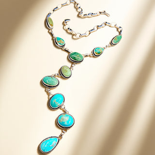 Necklace with turquoise stones on a beige background