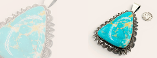 Turquoise stone pendant with silver setting on a white background