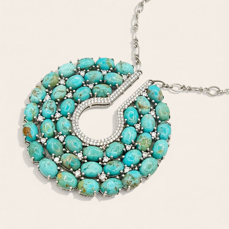 Turquoise necklace with silver accents on a white background