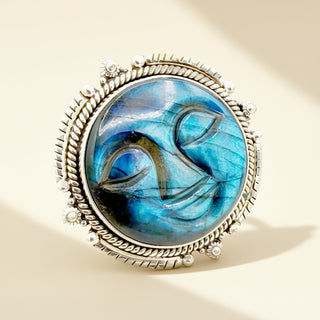 Jewelry with a blue stone and silver frame on a beige background