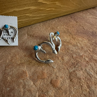 Silver earrings on an earthy background