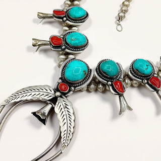 Silver and turquoise jewelry on a beige background