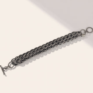 Silver braided bracelet on a white background
