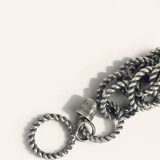 Silver chain necklace with a clasp on a white background