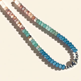 Beaded necklace with multicolored beads on a beige background