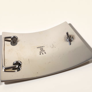 Metallic object with three toggle switches on a white background