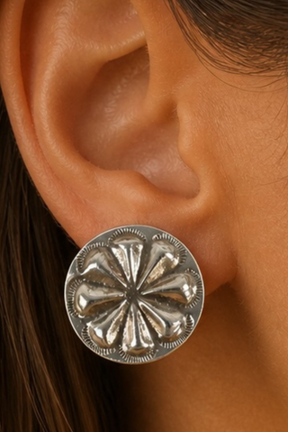 Silver earring on an ear 