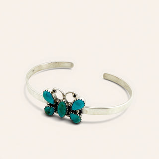 Silver bracelet with turquoise stones on a white background