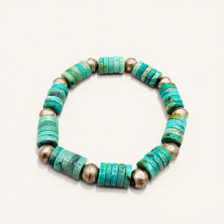 Turquoise and silver beaded bracelet on a white background