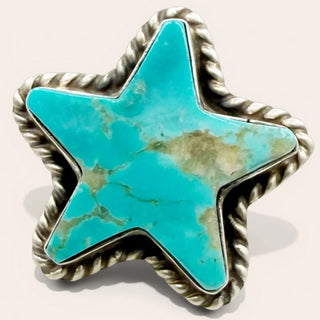 Star-shaped turquoise stone with silver border on a light beige background
