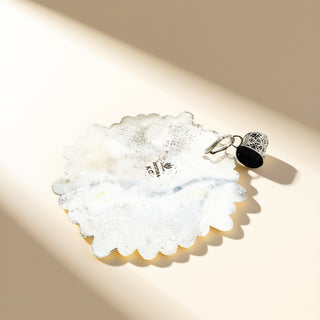 Silver pendant  stamp on a beige background