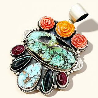 Colorful stone pendant with silver accents on a white background