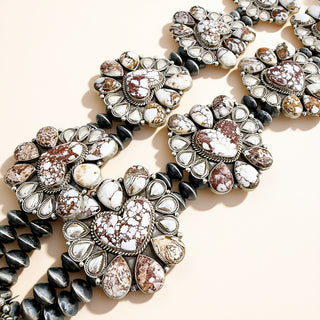 Decorative necklace with gemstone-like stones on a beige background