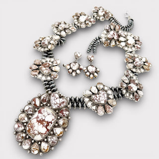 Jewelry set with necklace and earrings on a light gray background