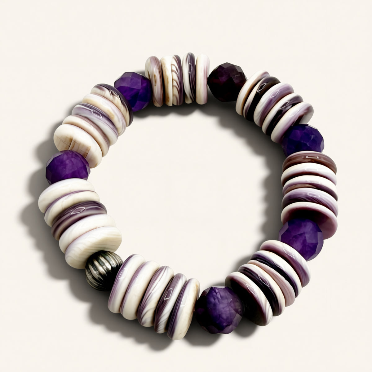 Bracelet with purple and white beads on a light background