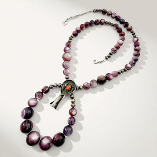 purple beaded necklace on a beige background