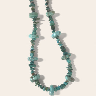 Turquoise stone necklace on a white background