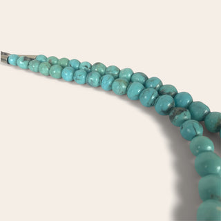 Turquoise beaded necklace on a light background