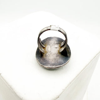Silver ring on a white surface