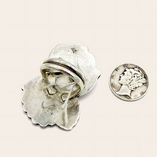 Silver ring and quarter on a beige background 