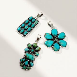 Three turquoise pendants on a white background