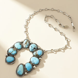 Necklace with turquoise stones on a beige background