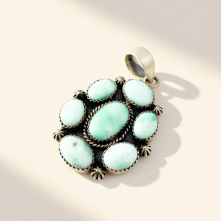 Turquoise stone pendant on a beige background