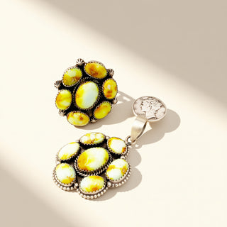 Jewelry pair with yellow gemstones on a light background