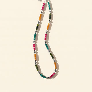 Colorful beaded necklace on a beige background