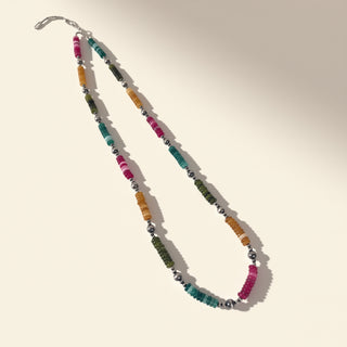 Colorful beaded necklace on a beige background