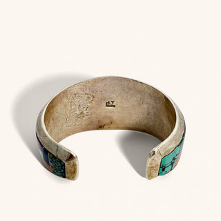 silver cuff with stamp on a beige background