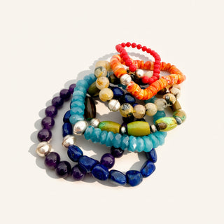 Colorful beaded bracelets on a white background