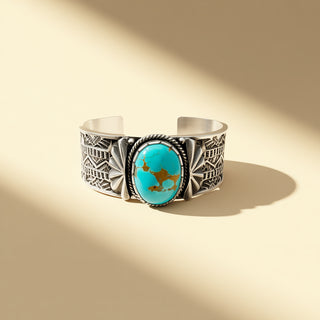 Silver bracelet with turquoise stone on a beige background