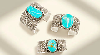 Three silver cuff bracelets with turquoise stones on a light background