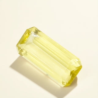 Rectangular yellow gemstone on a beige background