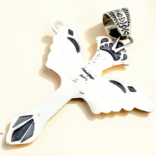 Silver pendant with stamp on a beige background