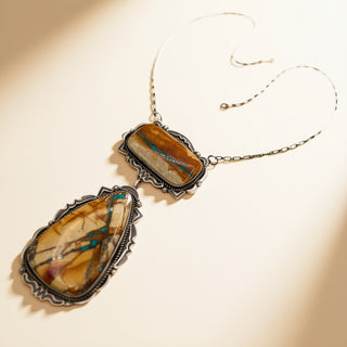 Necklace with large pendant featuring natural stone design on a beige background