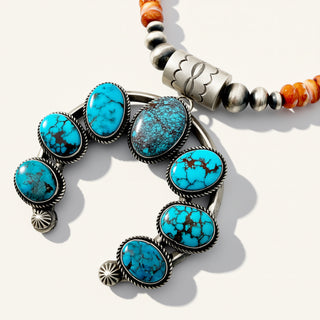 Bracelet with turquoise stones and silver accents on a white background