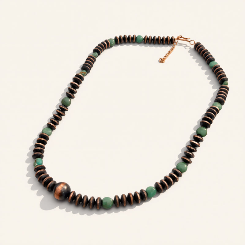 Necklace with brown and green beads on a white background
