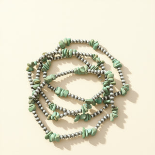 Beaded bracelets with turquoise stones on a beige background