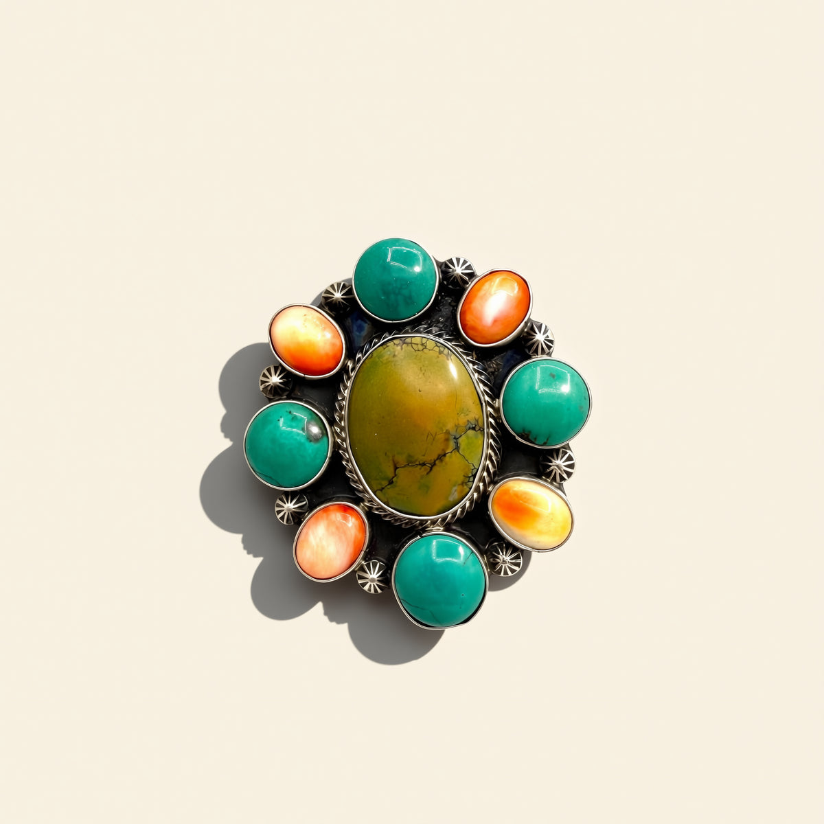 Jewelry with multicolored stones on a beige background