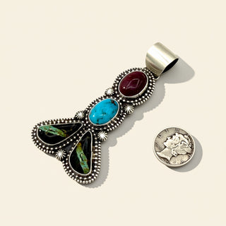 Multicolored stone pendant with a coin on a beige background