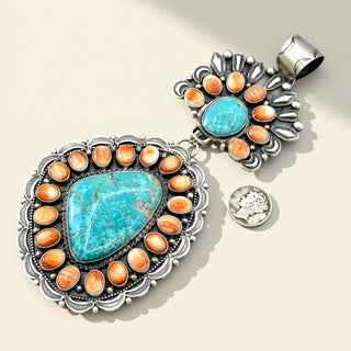 Two  stone pendant  with turquoise and orange stones on a beige background