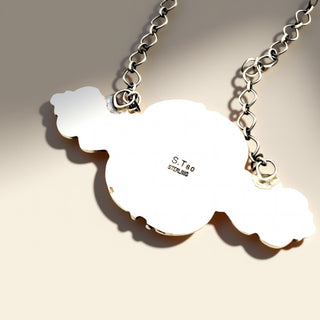 Necklace with cloud-shaped pendants on a beige background