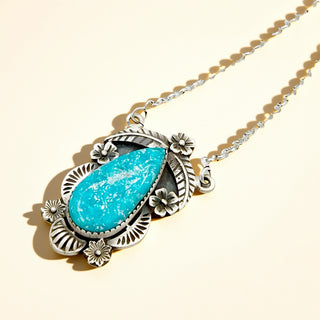 Necklace with a blue pendant on a beige background